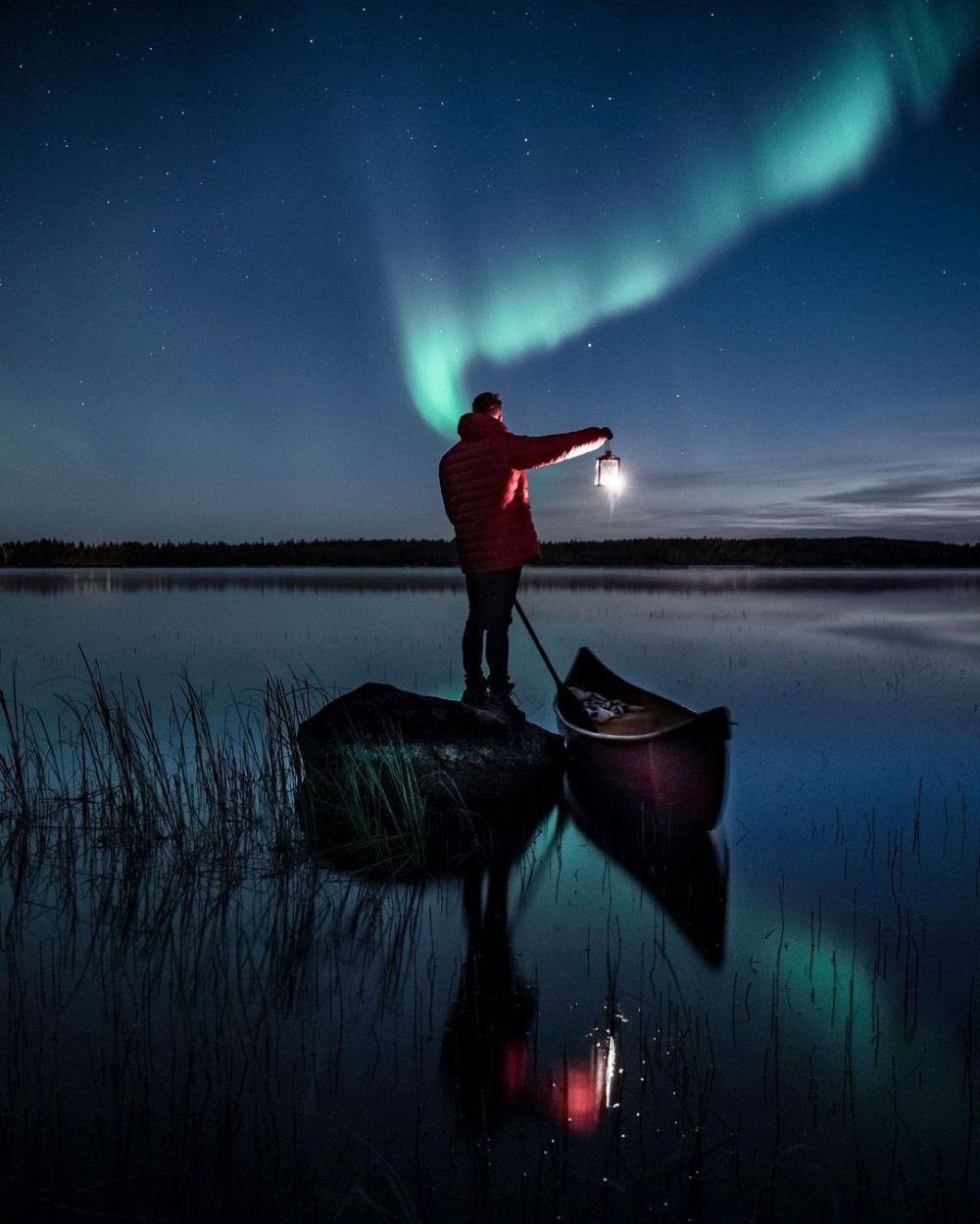 standing man on a small boat and the northern lights - 带上你最爱的人到芬兰Rovaniemi看浪漫的北极光！
